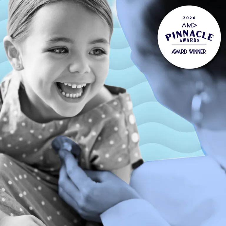 Smiling child with doctor being checked at Boys Town